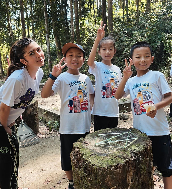 Teacher and children smiling during an outdoor activity